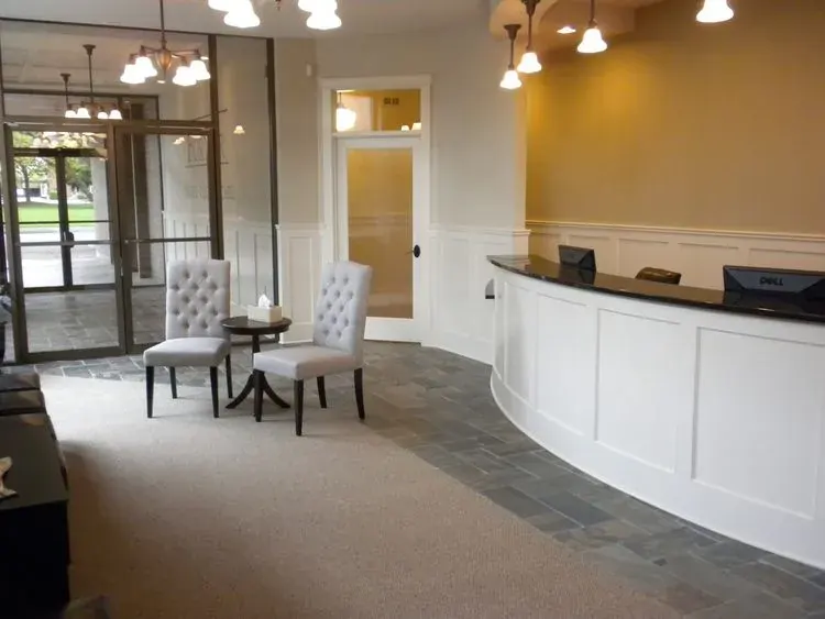 Front desk and wall clock in the Fortier Chiropractic lobby