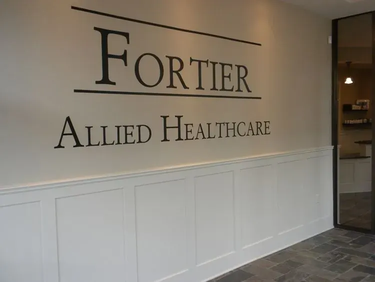 The curved reception desk with white wainscoting at Fortier Chiropractic